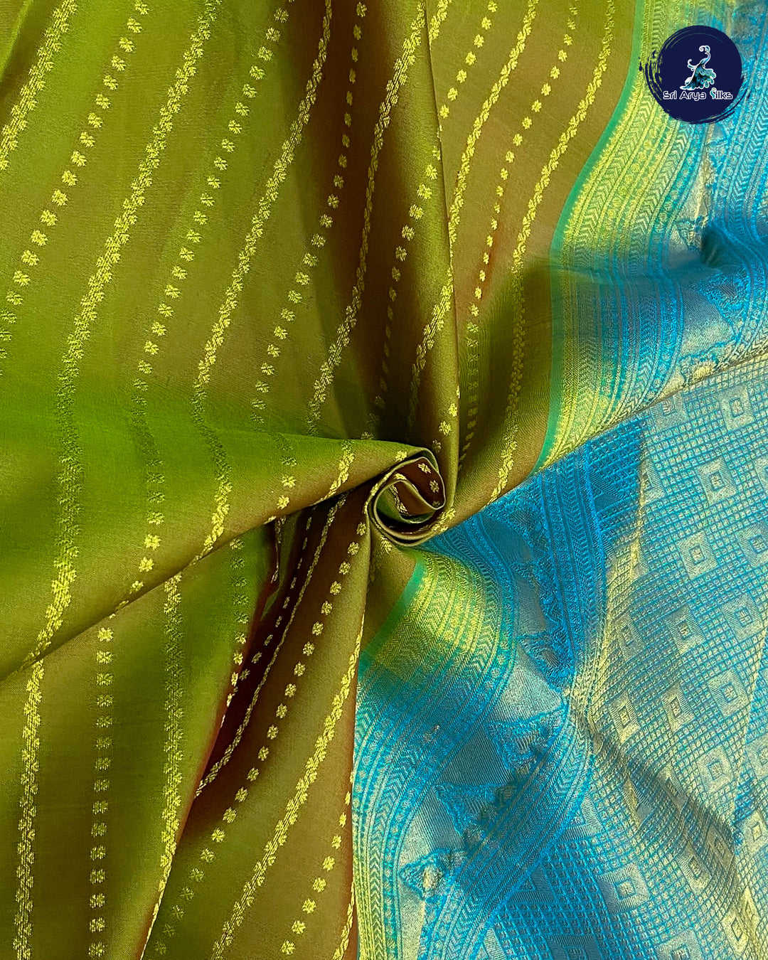 Mehendi Green Traditional Silk Saree With Copper Sulphate Blue Blouse & Buttas Pattern