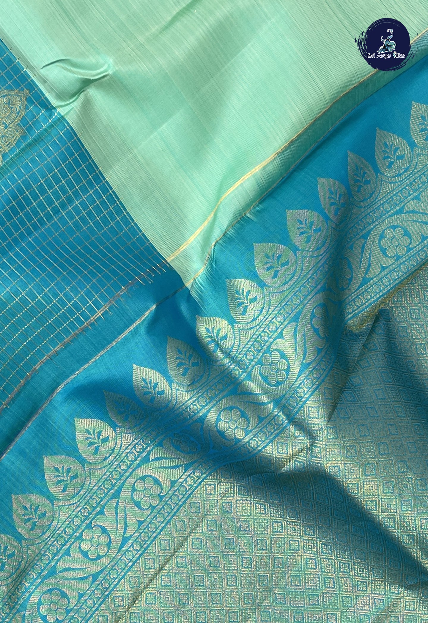 Pastel Green Half and Half Checked Silk Saree With Zari Buttas Pattern