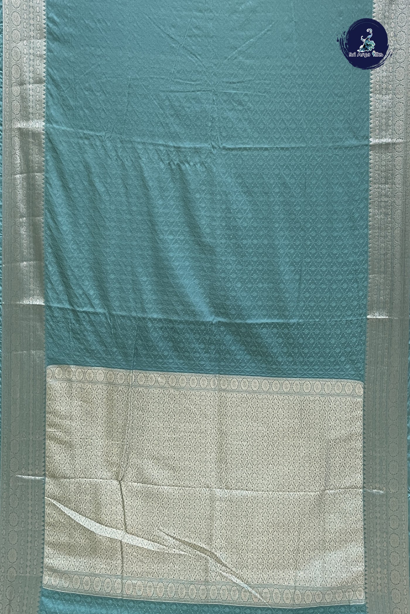 Teal Semi Raw Silk Saree With Embossed Pattern
