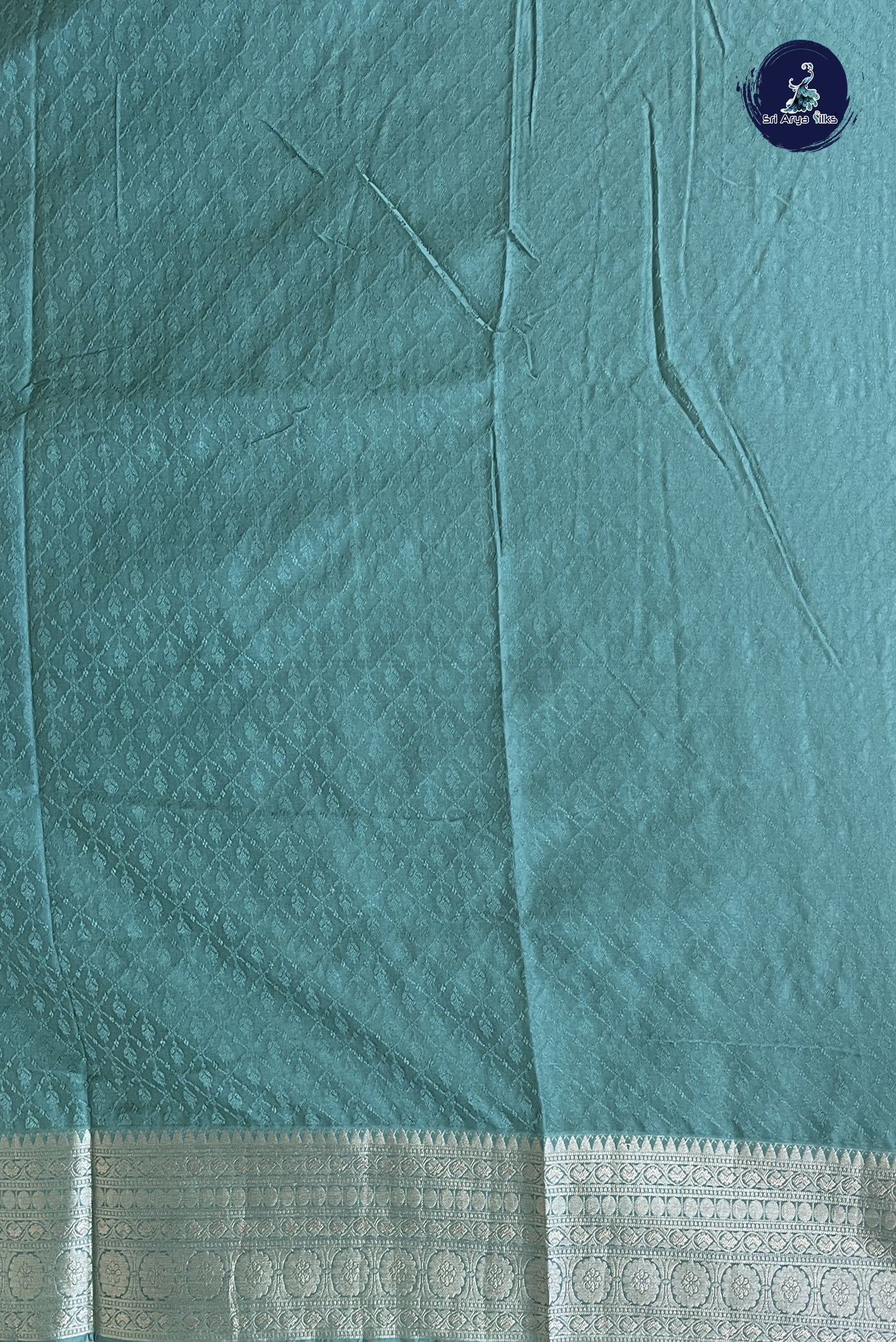 Teal Semi Raw Silk Saree With Embossed Pattern