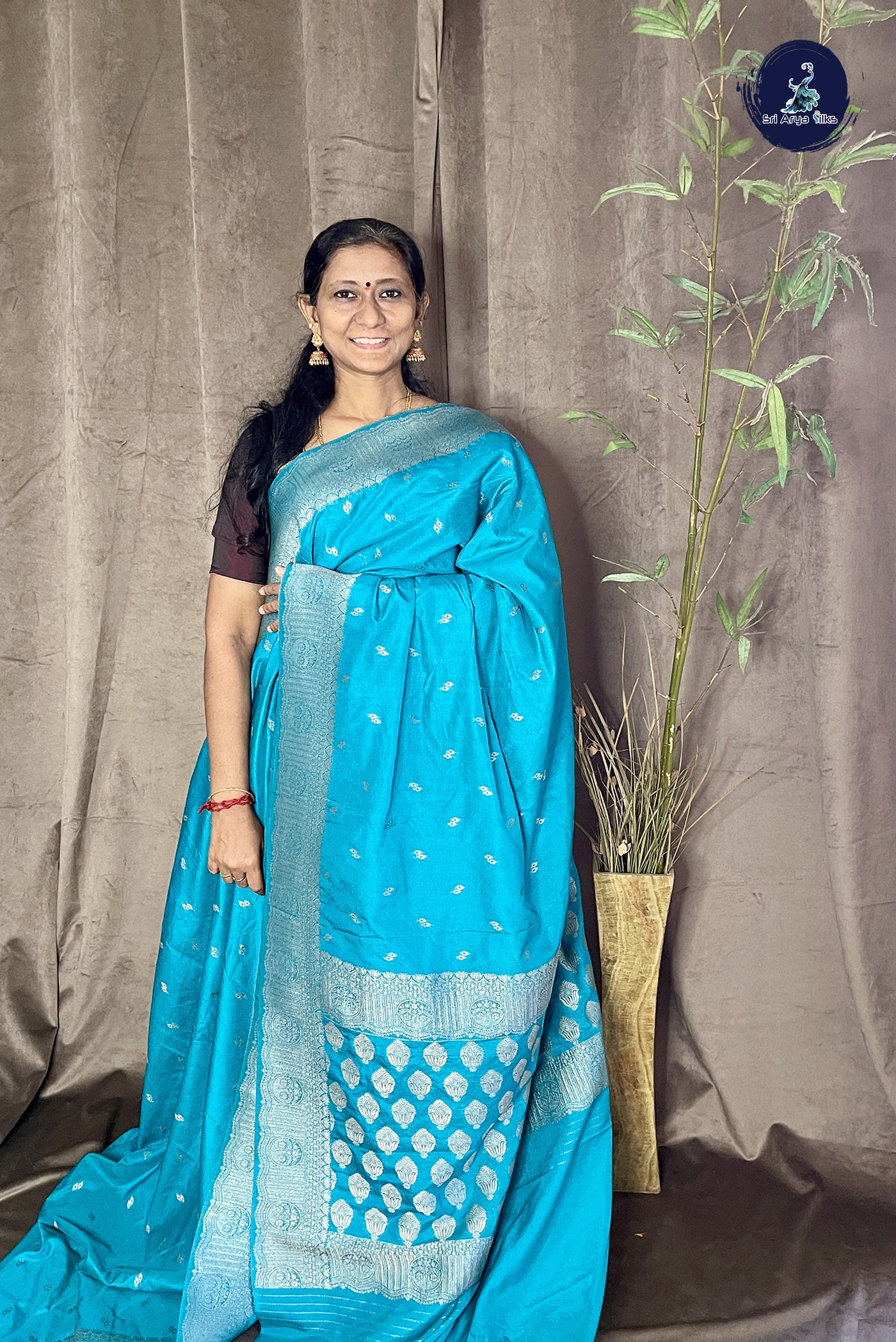 Teal Blue Georgette Banarasi Saree With Zari Buttas Pattern