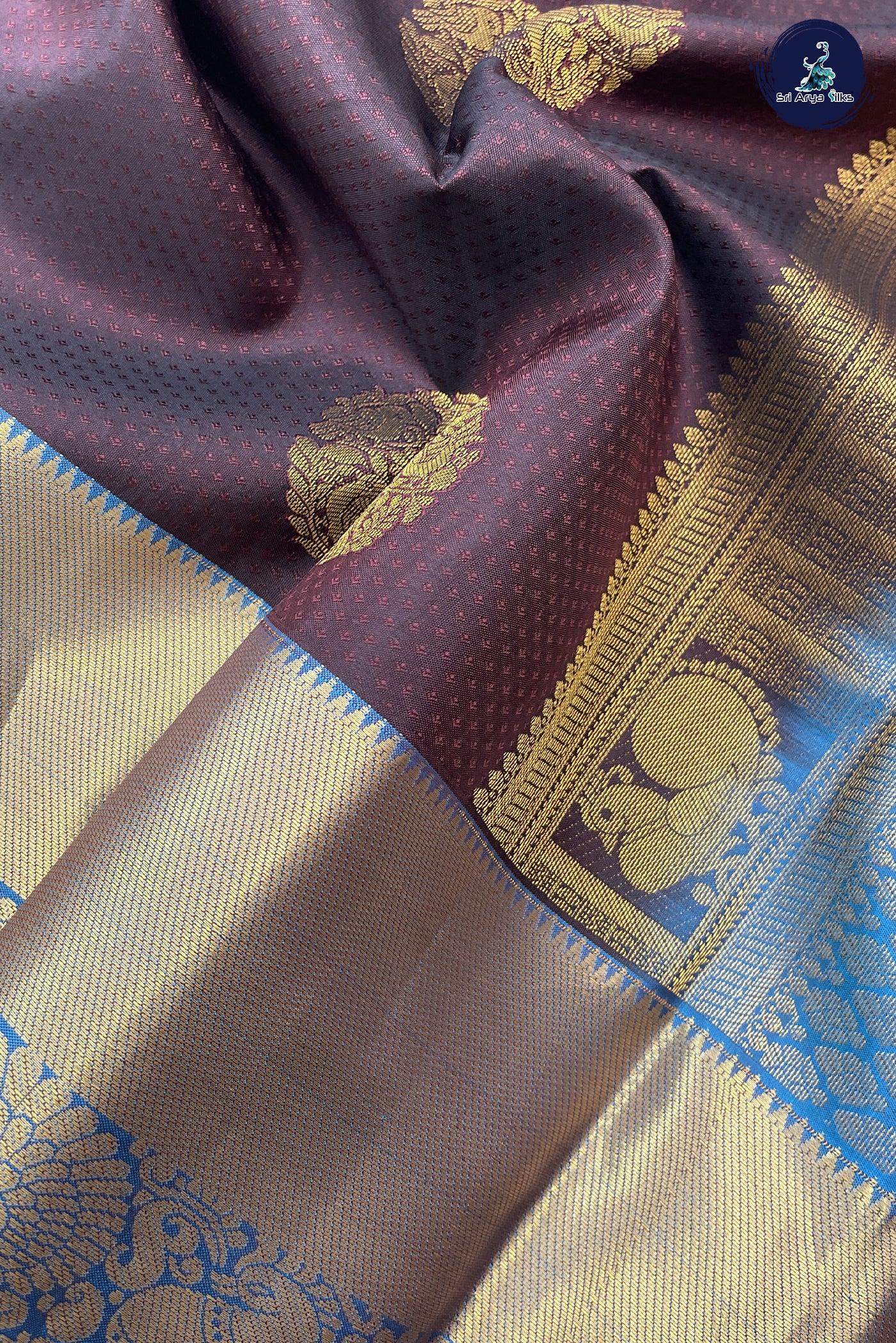 Coffee Brown Embosed Saree With Copper Sulphate Blue Blouse & Buttas Pattern