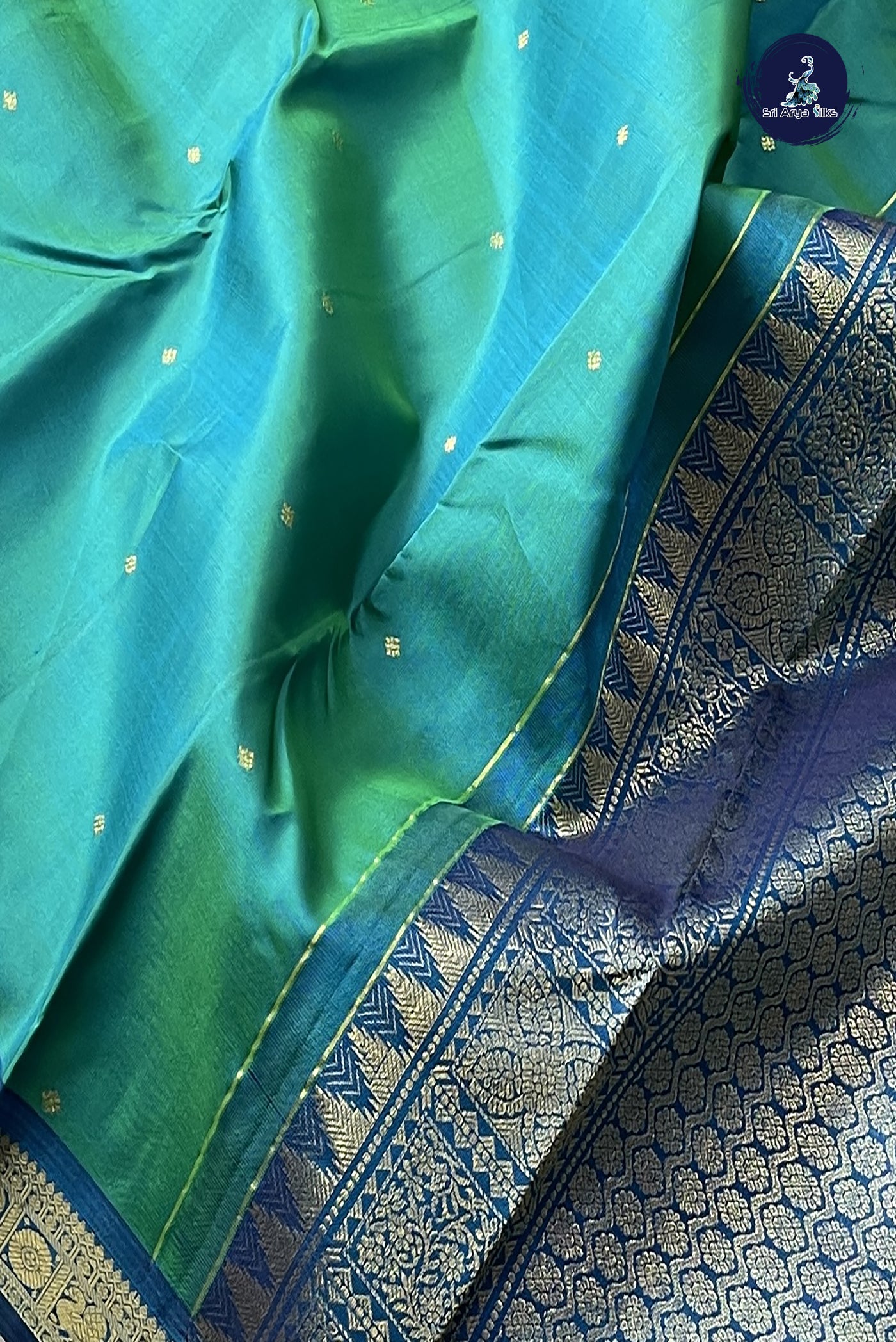 Bluish Green Light Weight Silk Saree With Zari Buttas Pattern