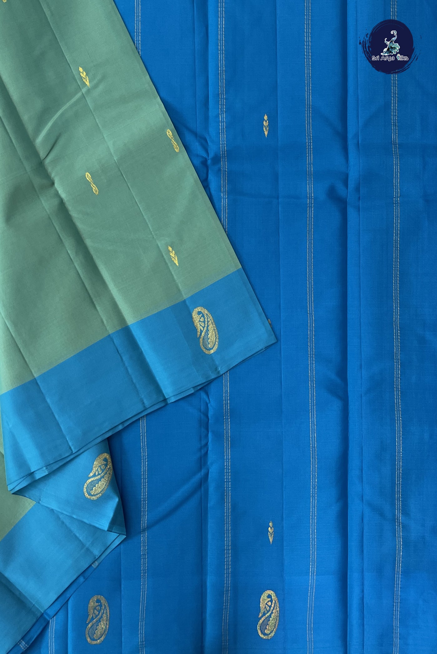 Bluish Green Light Weight Silk Saree With Zari Buttas Pattern