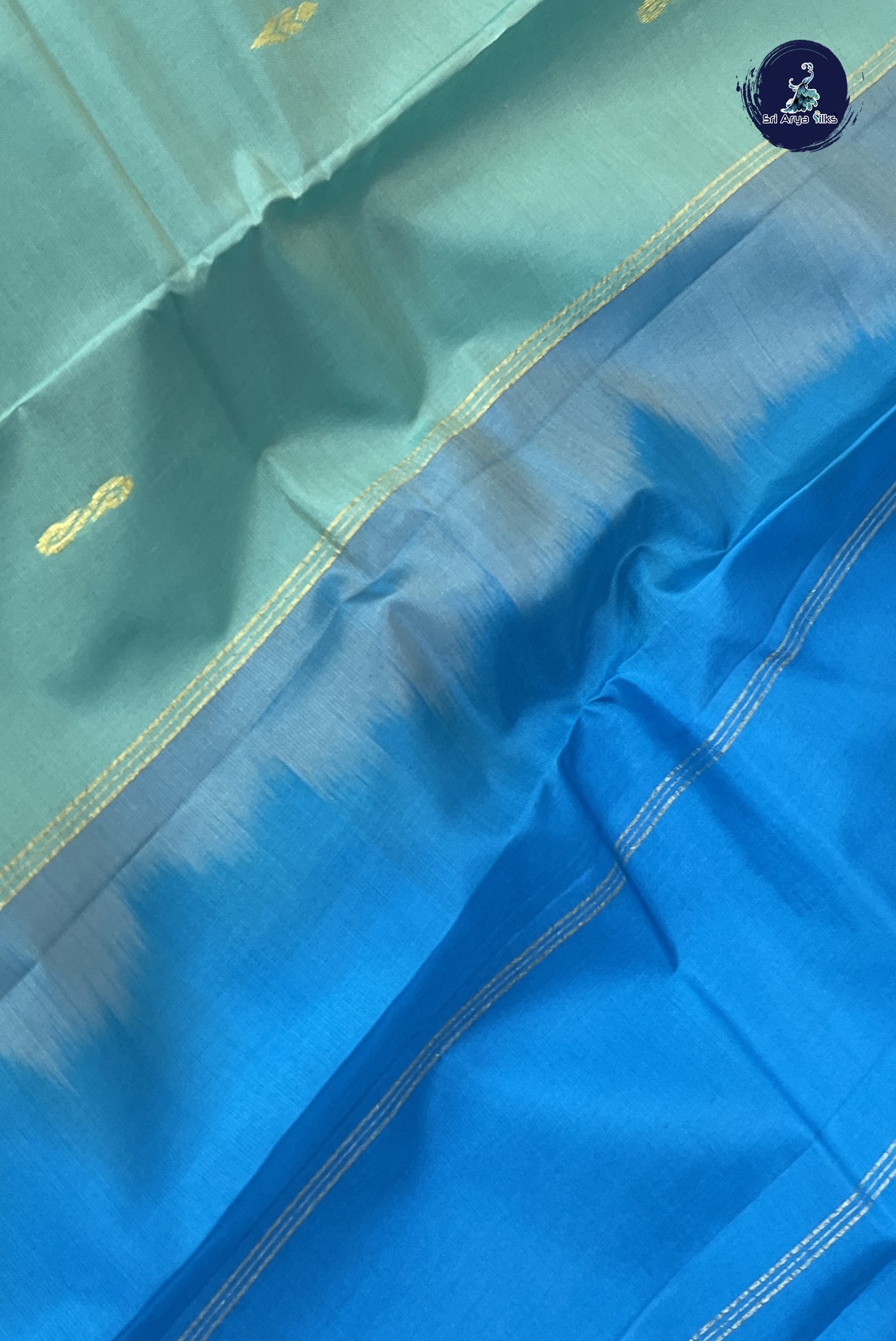 Bluish Green Light Weight Silk Saree With Zari Buttas Pattern